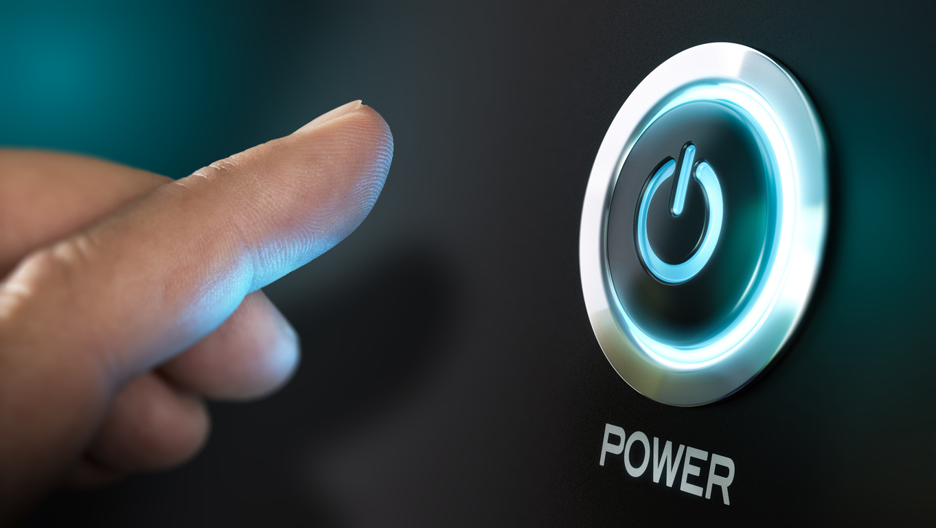 finger about to press a power button