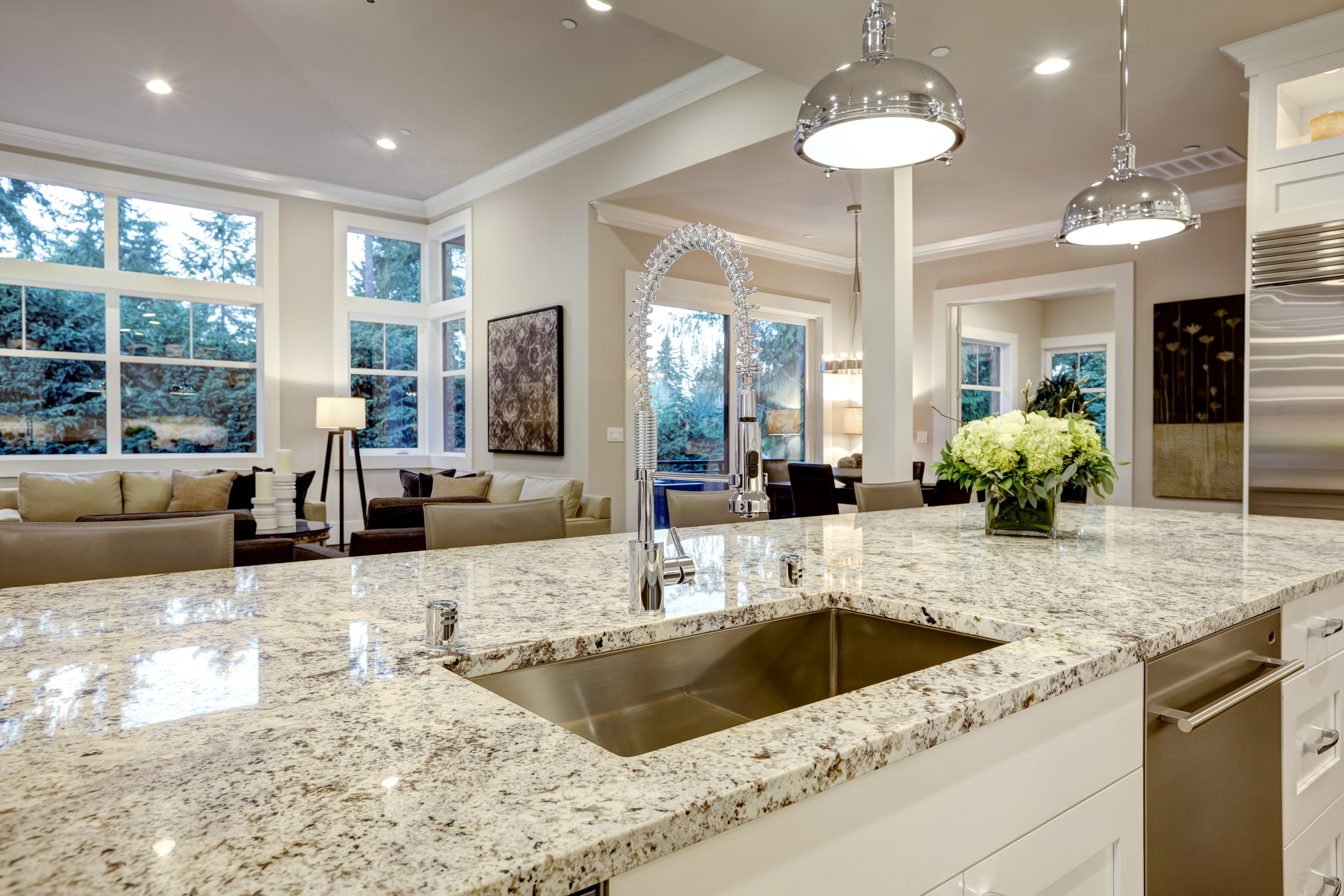 A kitchen with white and black granite countertops 