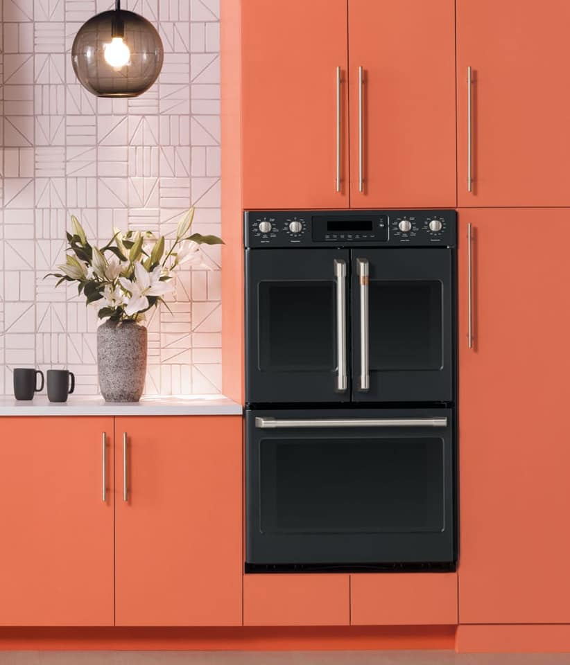A Café French door double wall oven installed into coral cabinets 