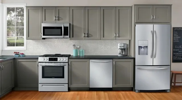 Modern kitchen with hardwood floors and outfitted with stainless steel Frigidaire appliances. 