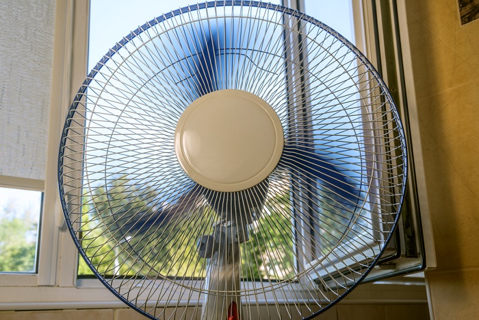 Fan is running near an open window.