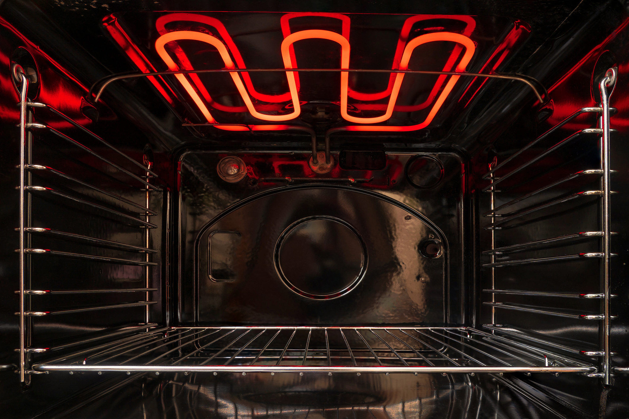 A shot of the interior of an oven with glowing heating elements 