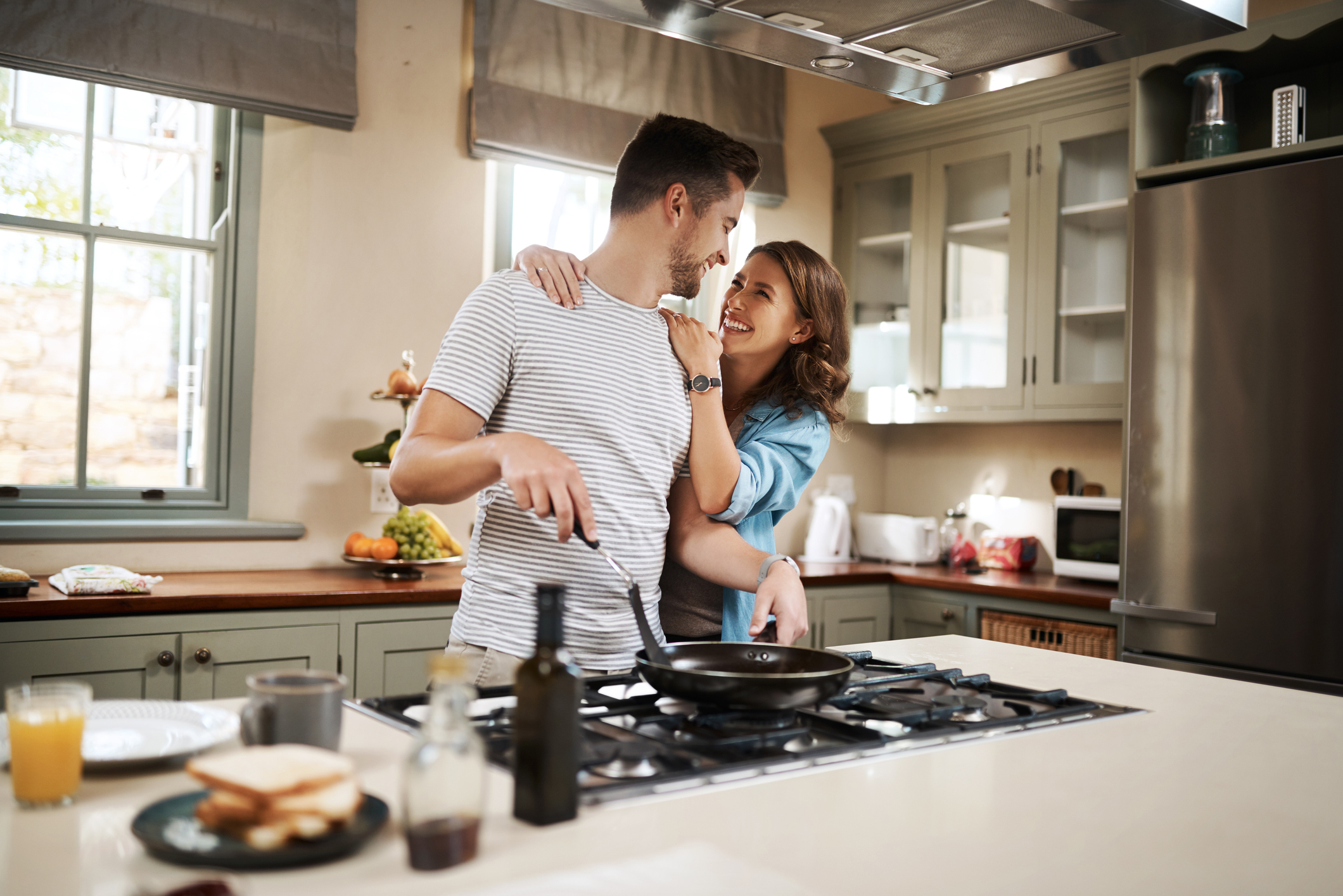  happy couple making breakfast together