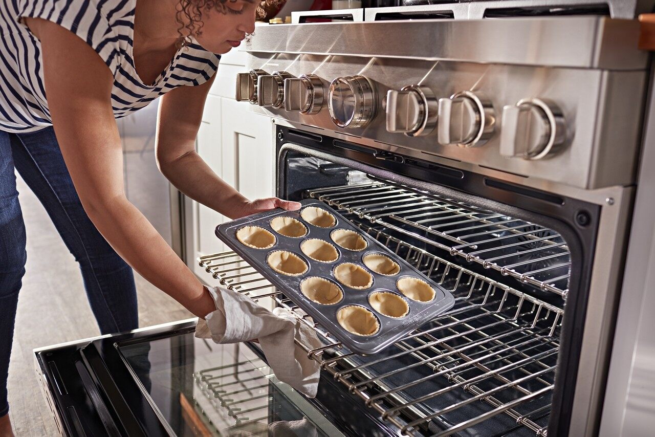 putting mini pie crusts into the oven