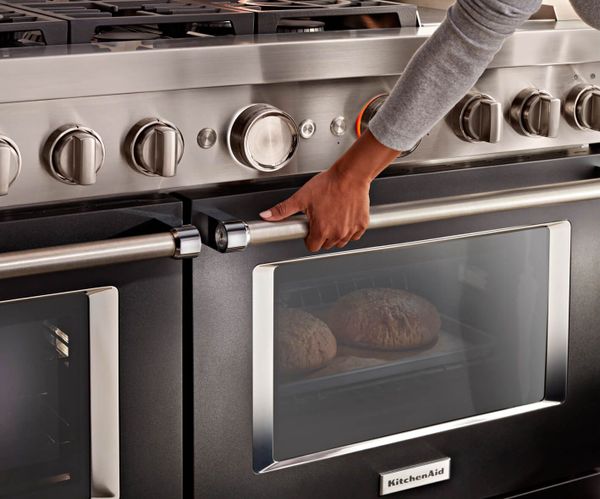 Woman demonstrating her kitchenaid range features 
