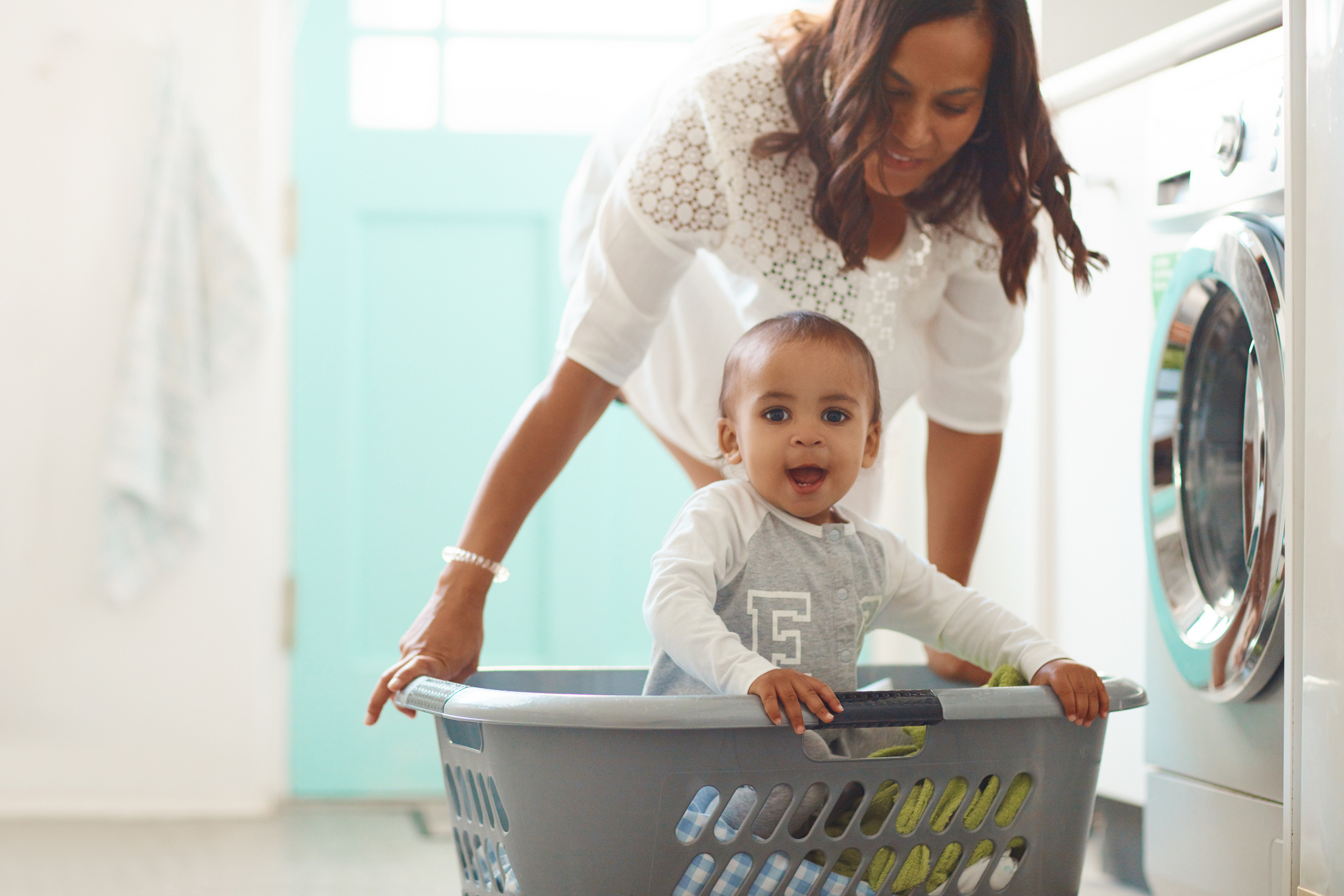 baby playing in the laundry basket