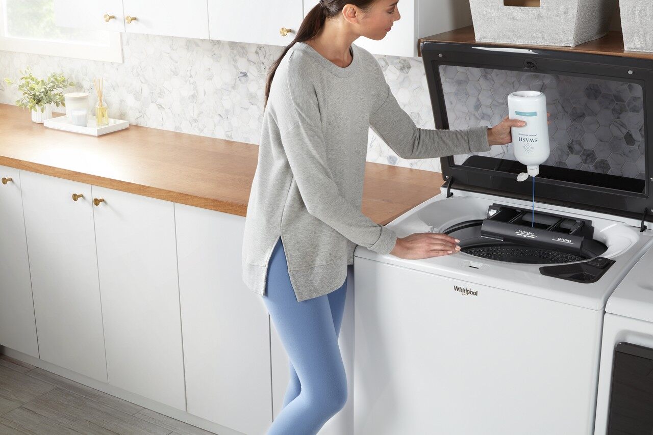  woman adding detergent into washer