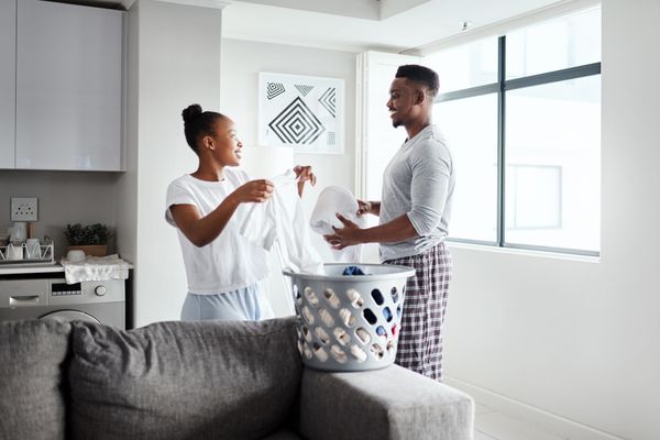 couple folding laundry together