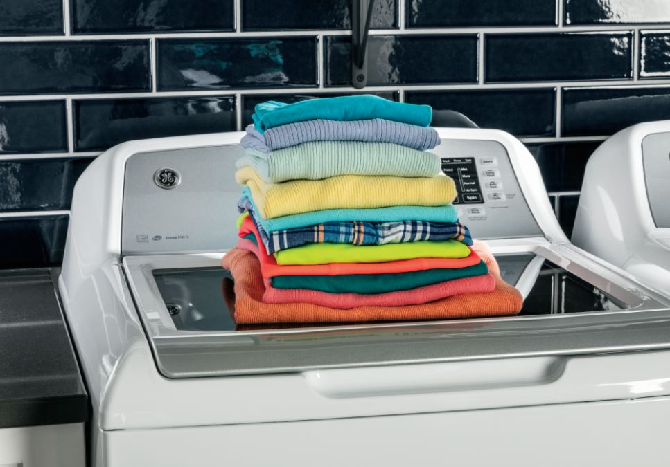 washer with clean stack of laundry on top