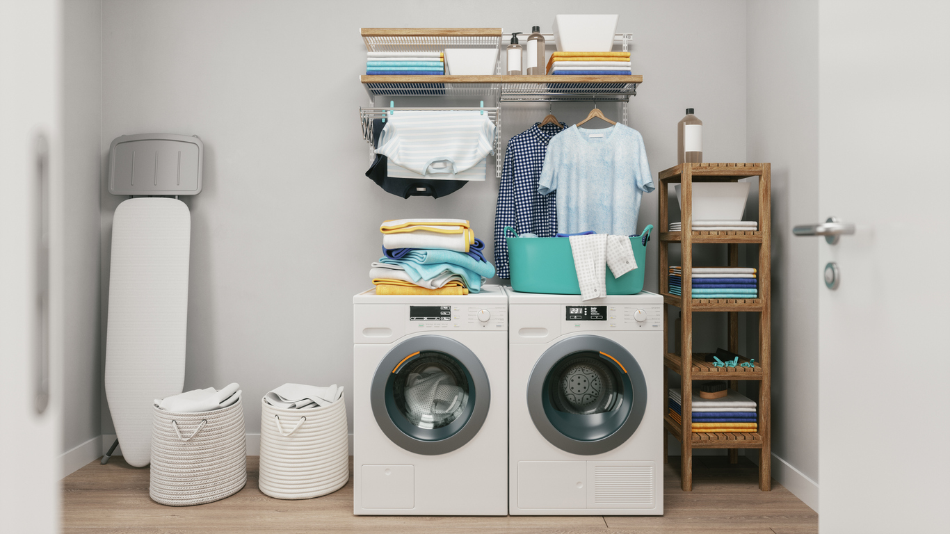 compact laundry setup featuring a wall-mounted rod for hanging clothes