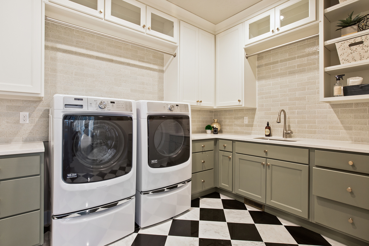 Laundry room with washer and dryer on pedestals
