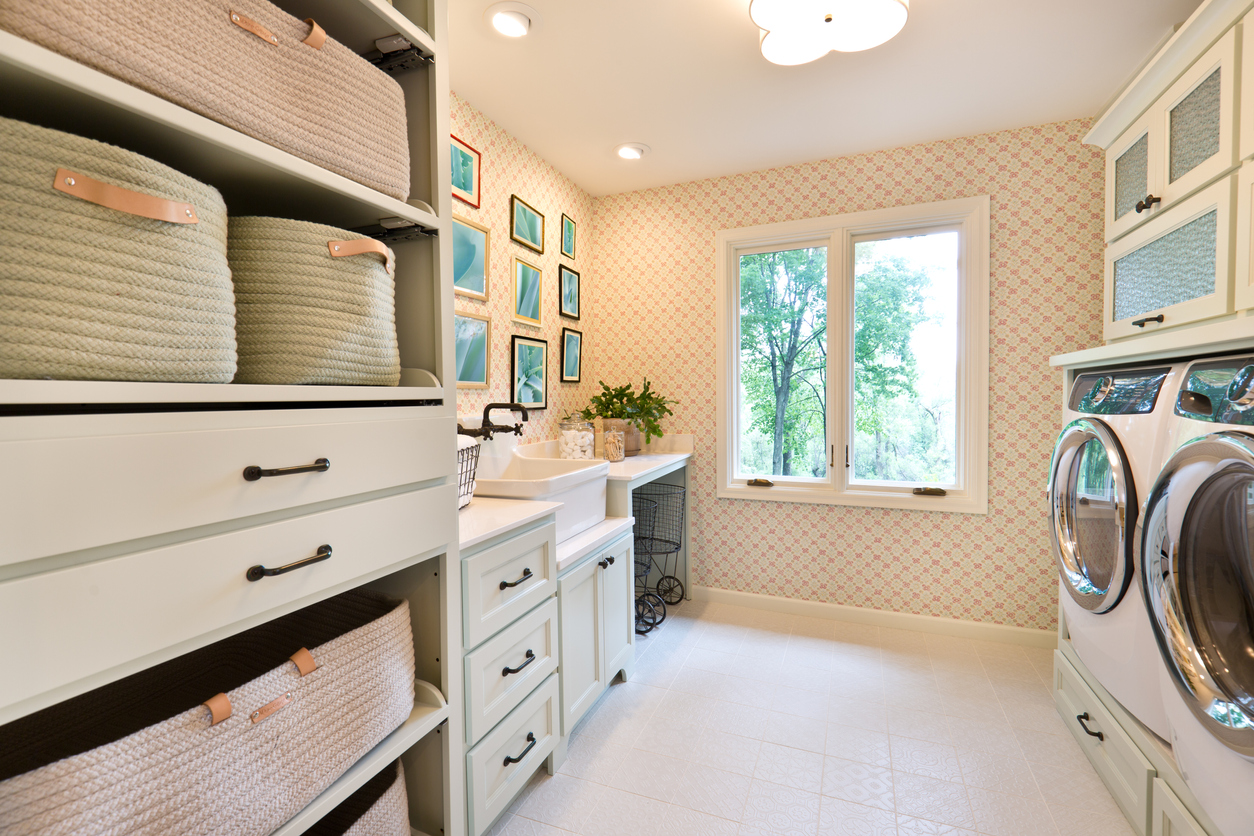 modern laundry room with cabinet and storage bins