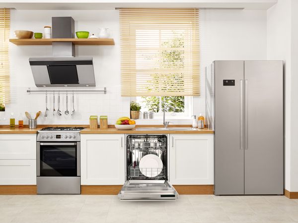 A kitchen featuring a side by side refrigerator, dishwasher, gas range, and ventilation 