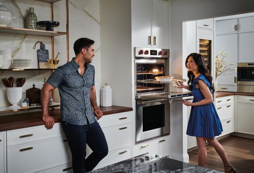 Couple Cooking in Kitchen with Luxury Appliances