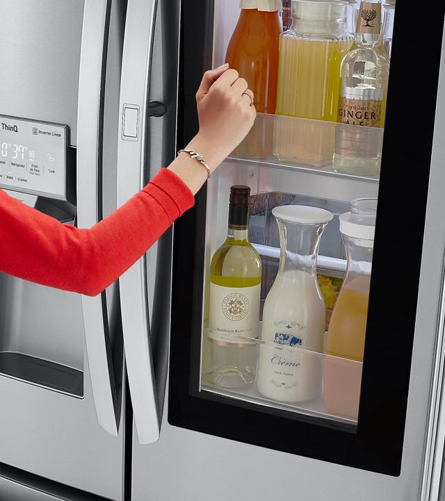 arm knocking on smart refrigerator to see inside