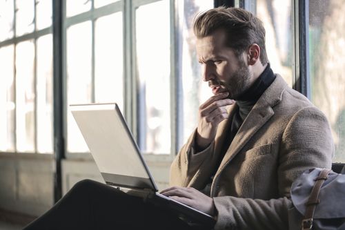 Man Looking for Answers on Laptop