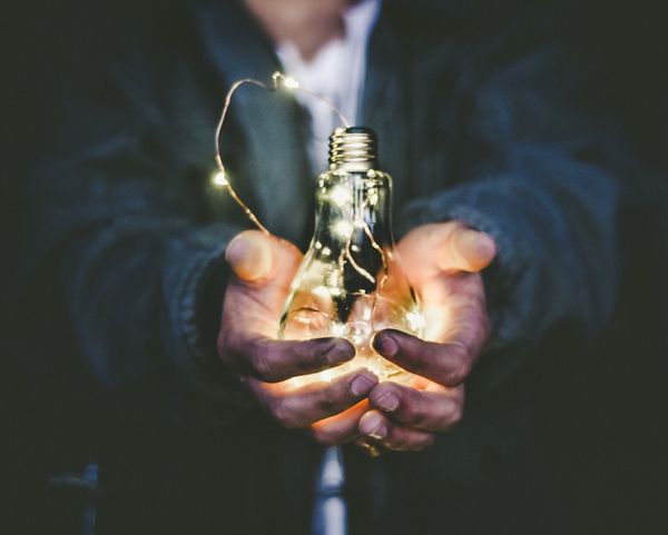 Man Holding A Light Bulb
