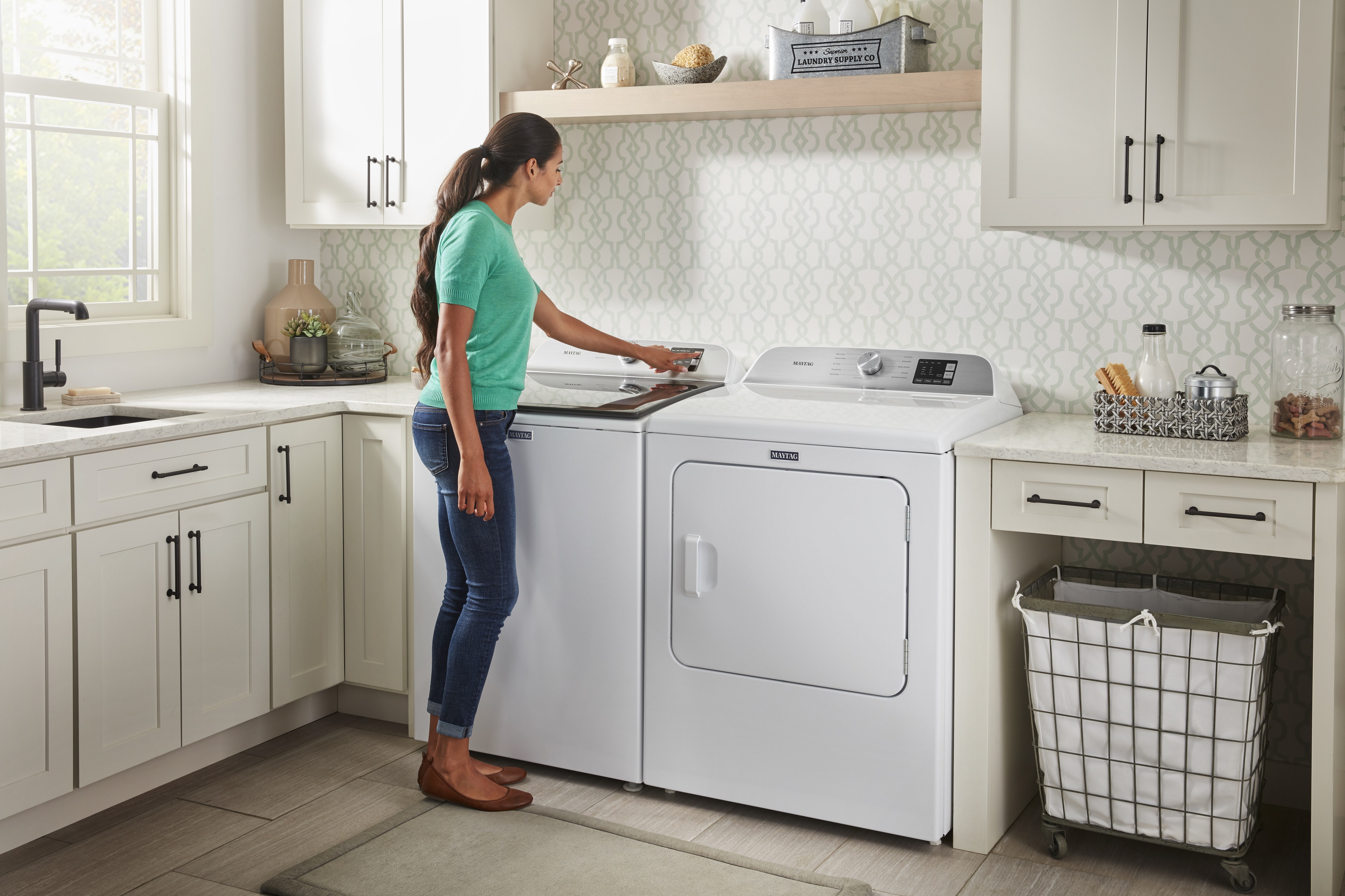 woman loads Maytag top-loading washer