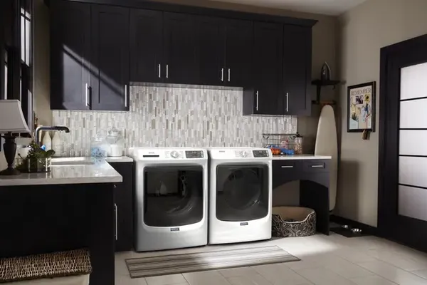 A Maytag front load washer and dryer in a laundry room