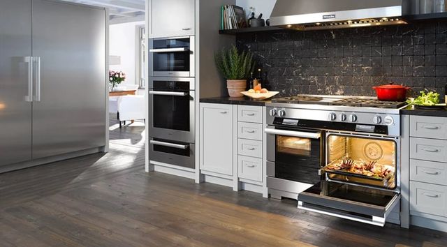 front view of a modern kitchen with stainless steel miele appliances throughout