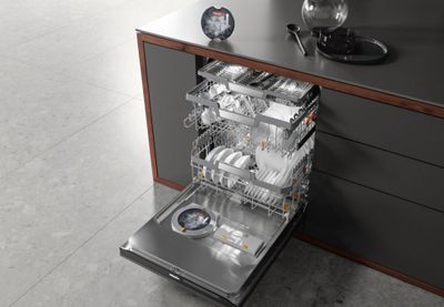 An open Miele dishwasher