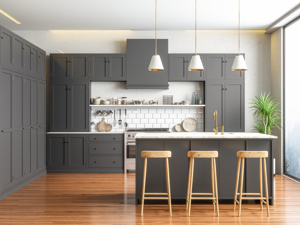 A kitchen with gray cabinets and a kitchen island with a marble countertop
