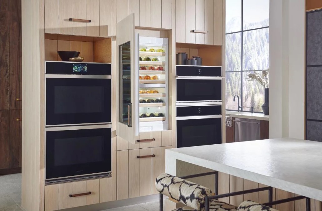Monogram wine cooler in a kitchen installed next to Monogram ovens