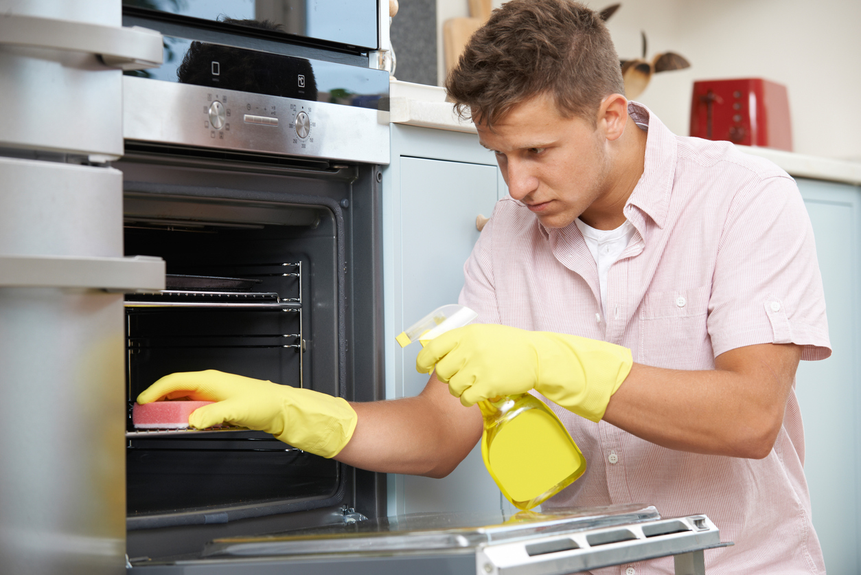 a man cleans his oven