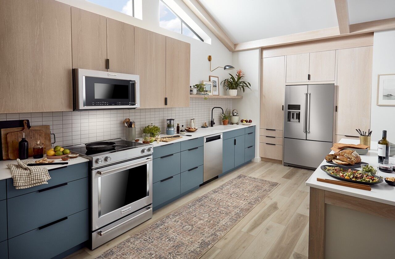 A blue-themed kitchen with various KitchenAid appliances 