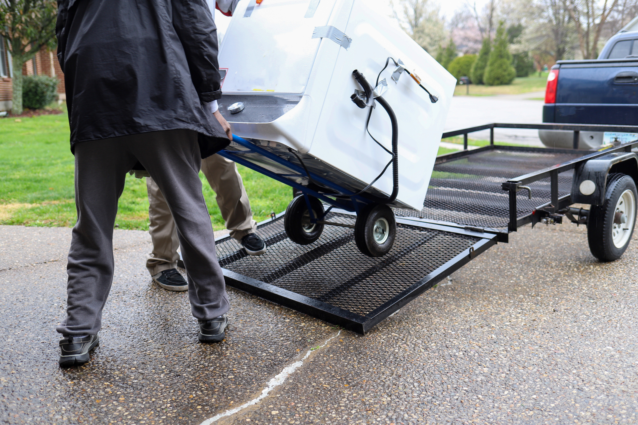 A man hauling away a dryer