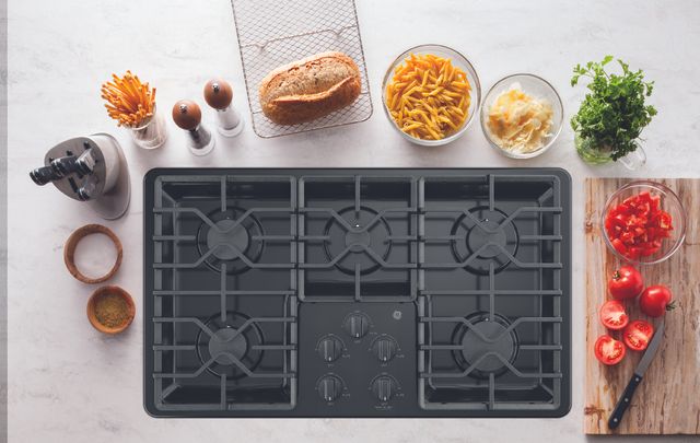ariel view of a gas cooktop surrounded by cooking ingredients