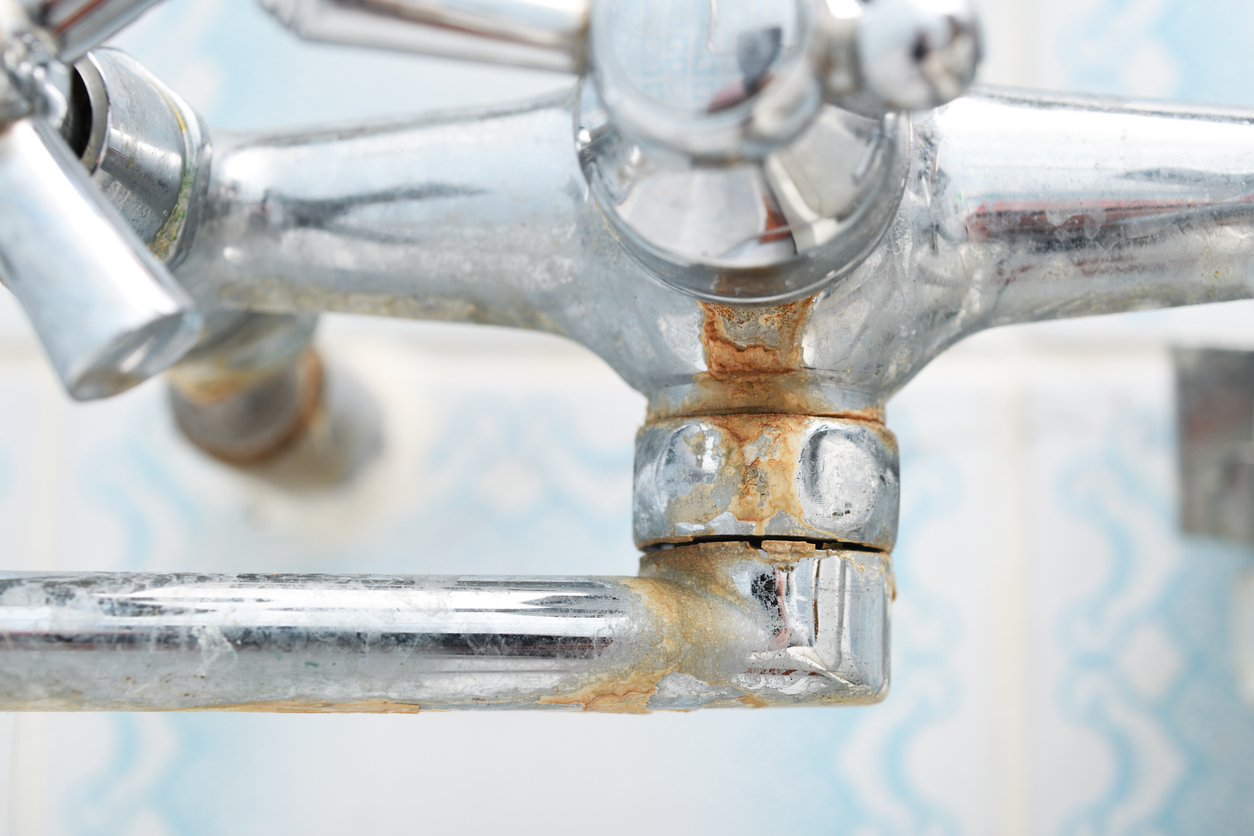 closeup of bath faucet with limescale buildup