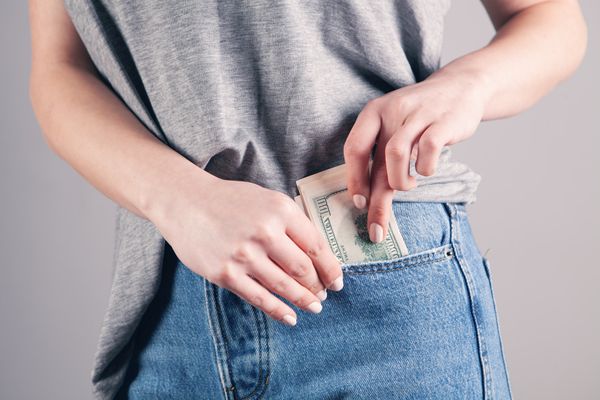 Woman saving money inside her pocket "Credit: Sasun Bughdaryan"