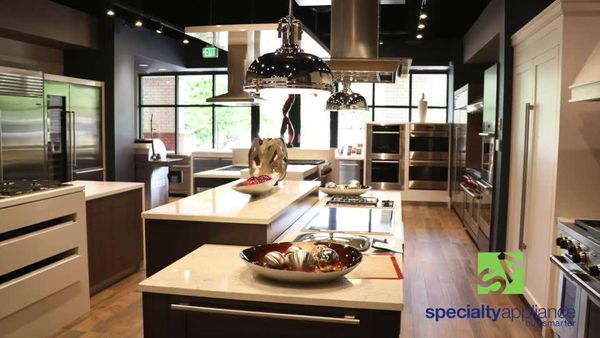 A luxury kitchen with a Specialty Appliance logo overlay 