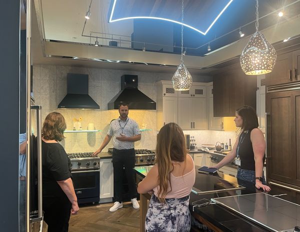 A Specialty Appliance salesman demonstrating appliances to a group 