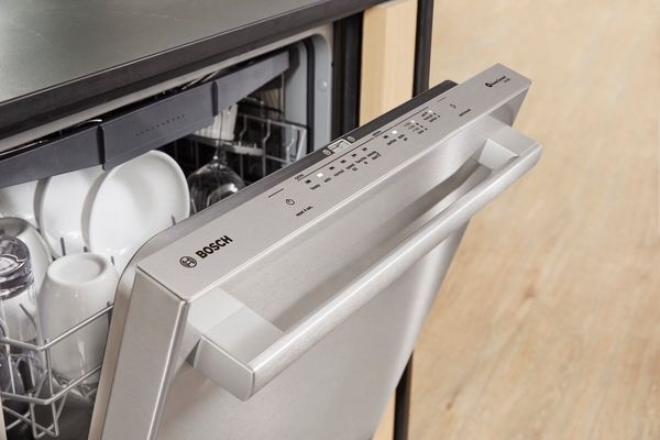 An up-close look at a Bosch dishwasher with its door open 