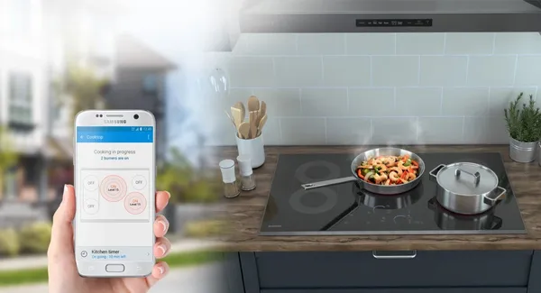 A graphic of a person using a connected app with the Samsung NZ30K7570RS cooktop 