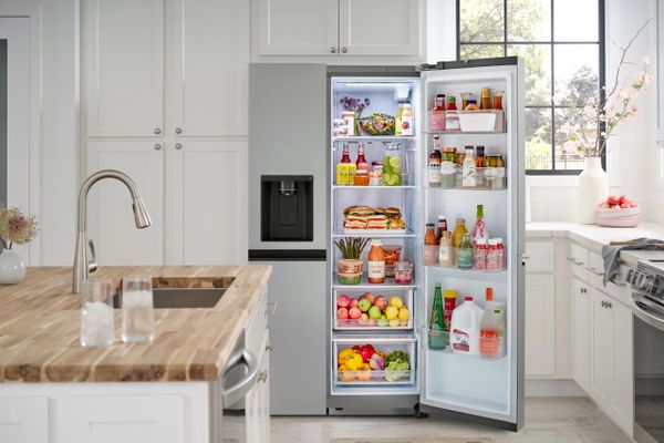 The LG LRSXS2706S refrigerator with its door open displaying various foods
