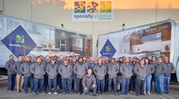 Employees at Specialty Appliance posing outside of a store