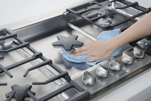 Credit: Thermador An owner cleaning a Thermador gas cooktop