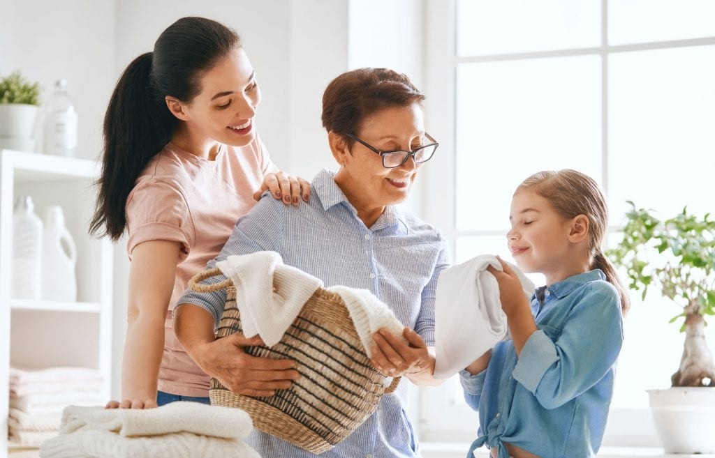grandmother, mother, and daughter do laundry together