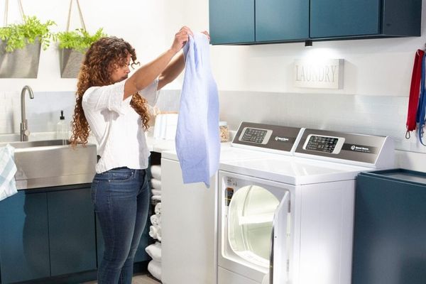 Woman Using Speed Queen top load Washer