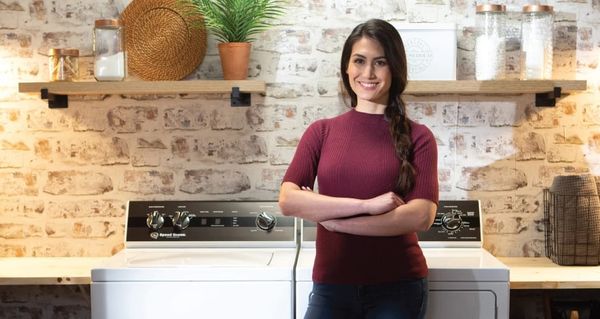 Woman Standing in Front of Speed Queen Washer
