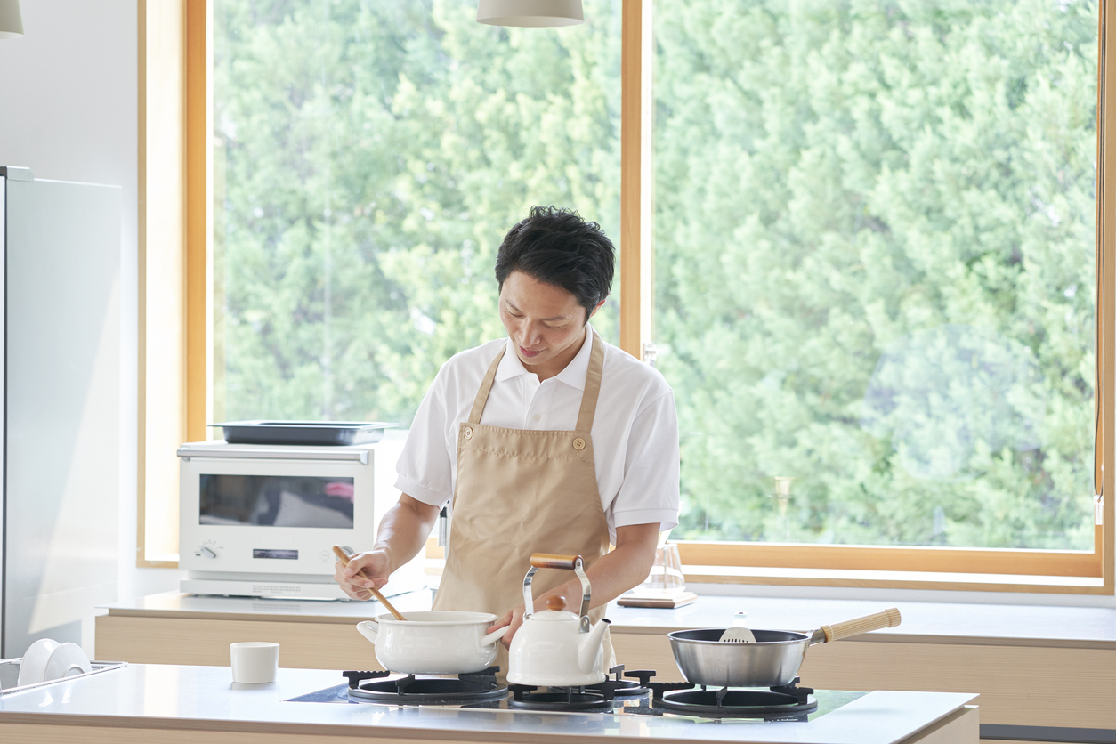 man cooking on clean, pristine cooktop