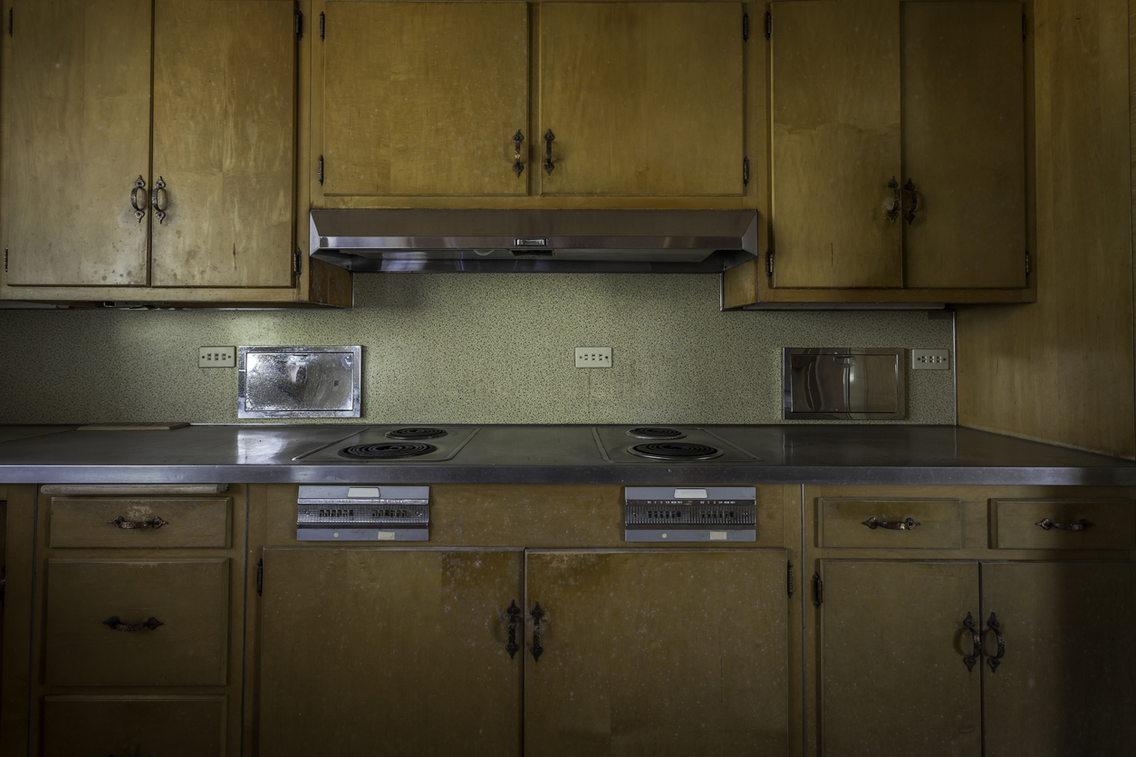 70s style kitchen with outdated wood cabinetry 