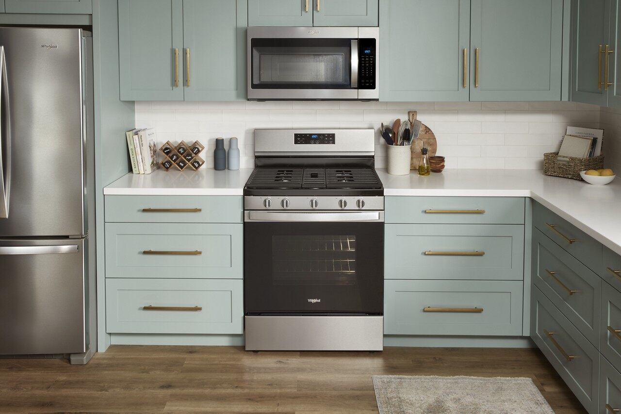 a blue kitchen with a new electric range