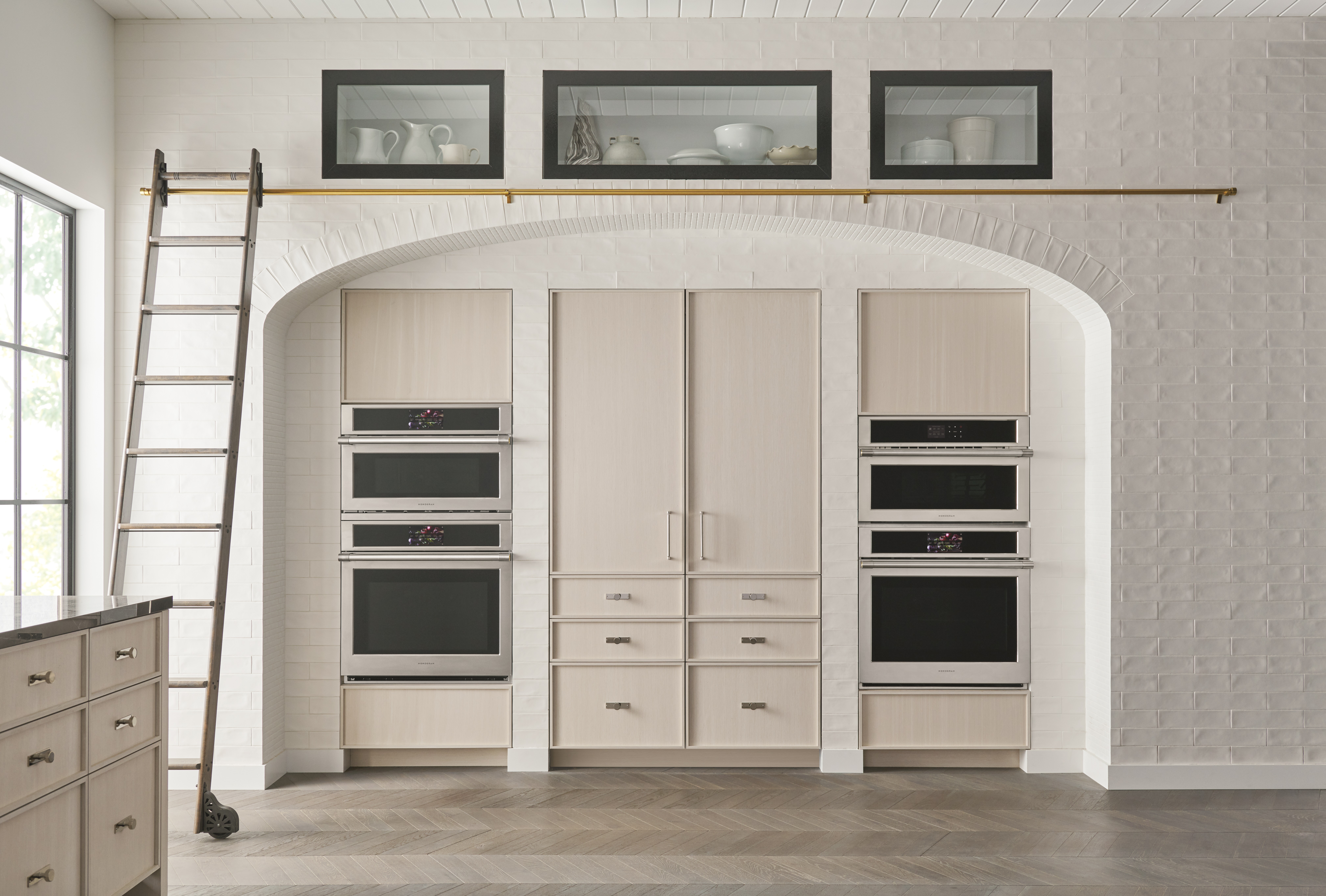 A matching Monogram column refrigerator and freezer in a farmhouse-style kitchen 