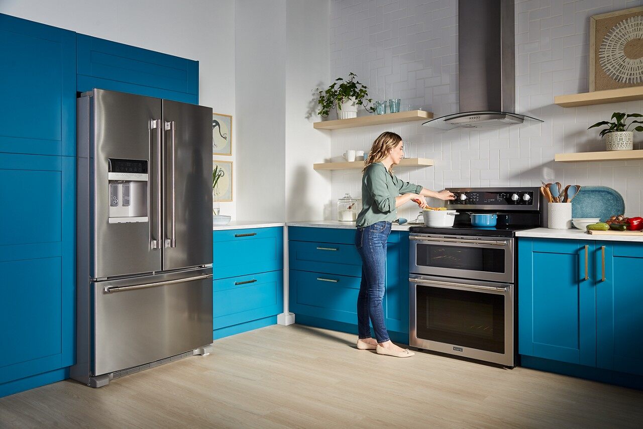 woman cooking on electric range in kitchen