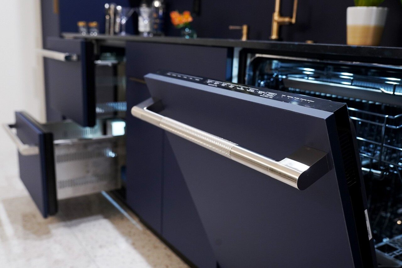 JennAir high-end dishwasher in a black finish shown with its door slightly open 