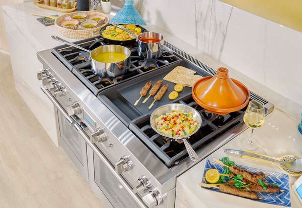 Overhead of a Thermador 48-inch pro-style range with several items cooking atop 